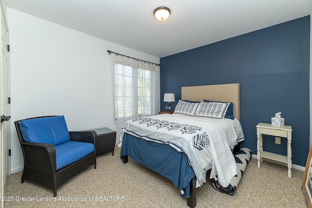carpeted bedroom featuring baseboards