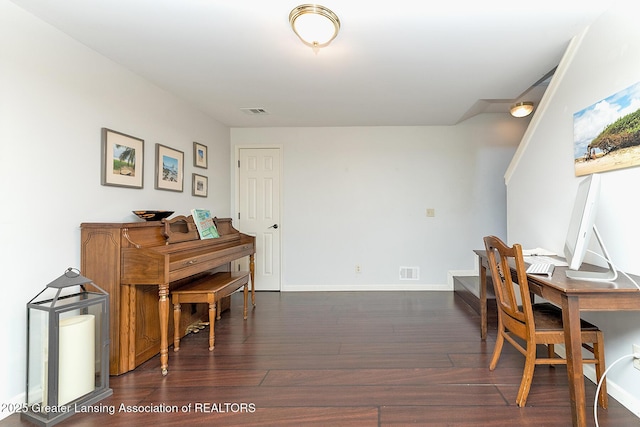 dining room featuring dark wood finished floors, visible vents, and baseboards