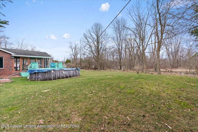 view of yard with a covered pool