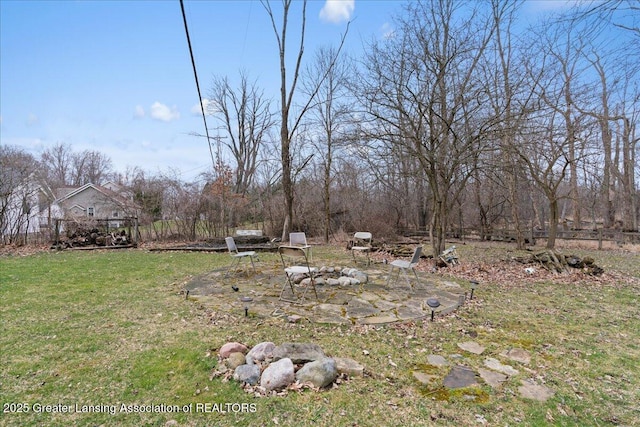 view of yard featuring a fire pit and a patio