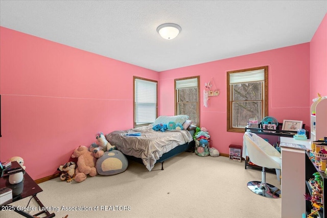 carpeted bedroom with baseboards and a textured ceiling