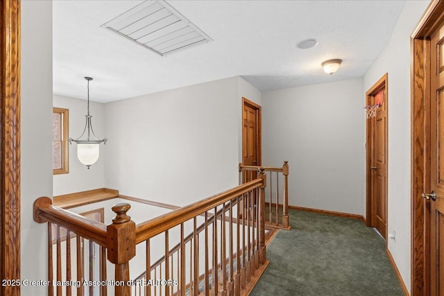 hall featuring baseboards, carpet flooring, an upstairs landing, and visible vents