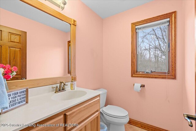 bathroom with toilet and vanity