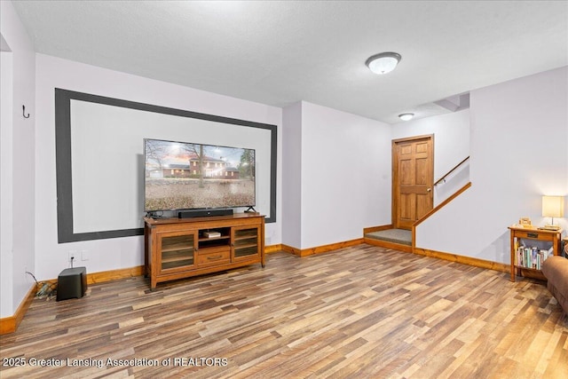 interior space with baseboards and wood finished floors