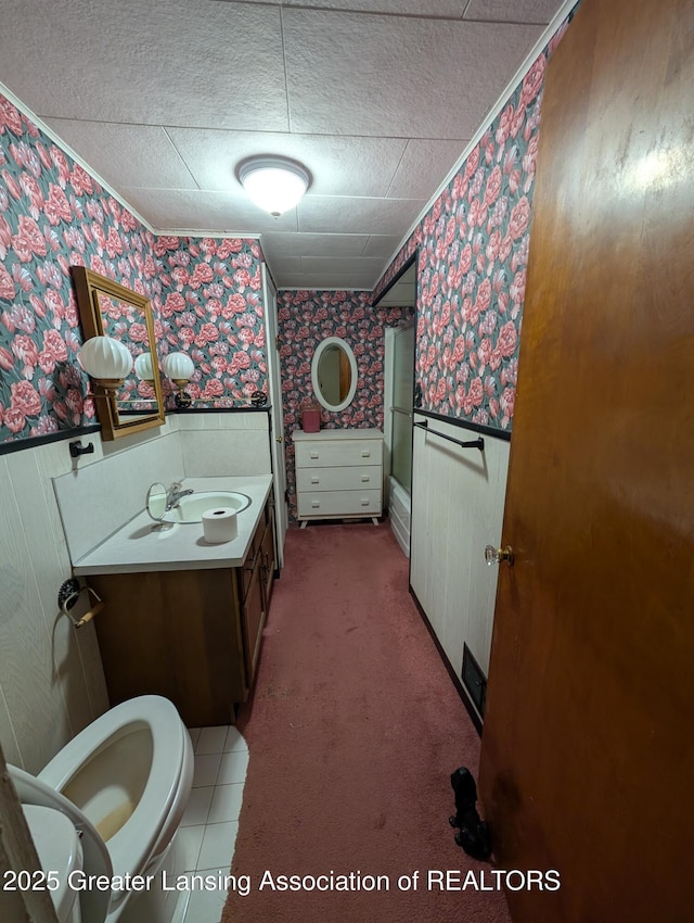 12302 Sandborn Rd, Portland, MI 48875 - bathroom featuring vanity, toilet, wallpapered walls, and a wainscoted wall