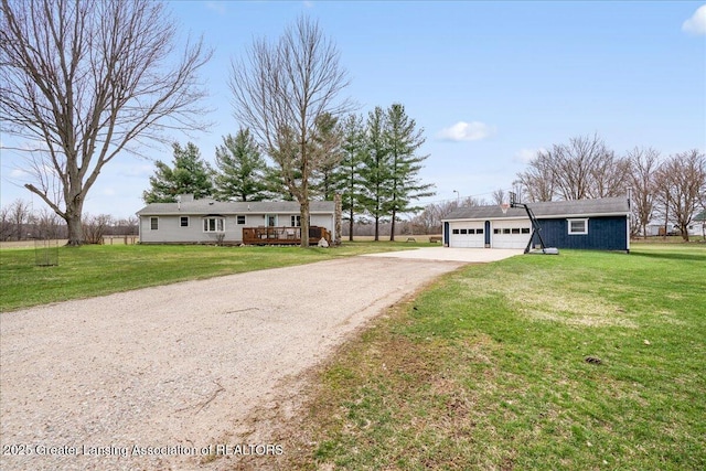 ranch-style home with a front yard, a garage, and dirt driveway