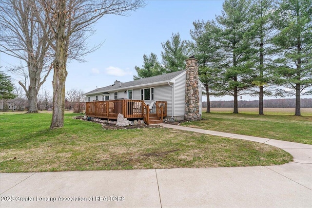 view of front of home featuring a front lawn, a chimney, and a deck