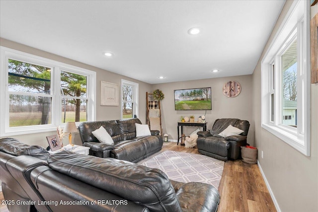 living room with baseboards, wood finished floors, and recessed lighting