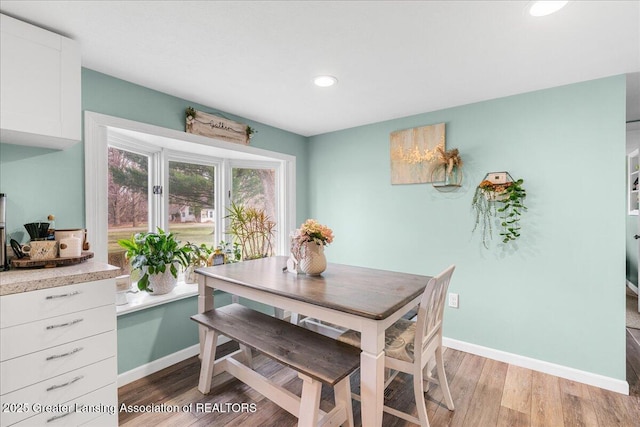 dining area featuring recessed lighting, baseboards, and light wood-type flooring