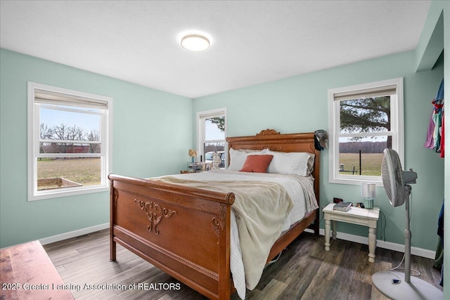 bedroom with baseboards and wood finished floors