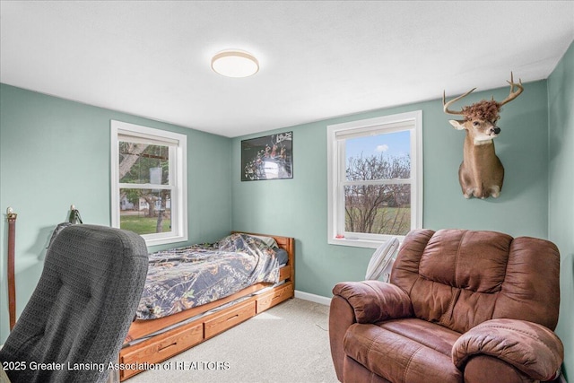 carpeted bedroom featuring baseboards