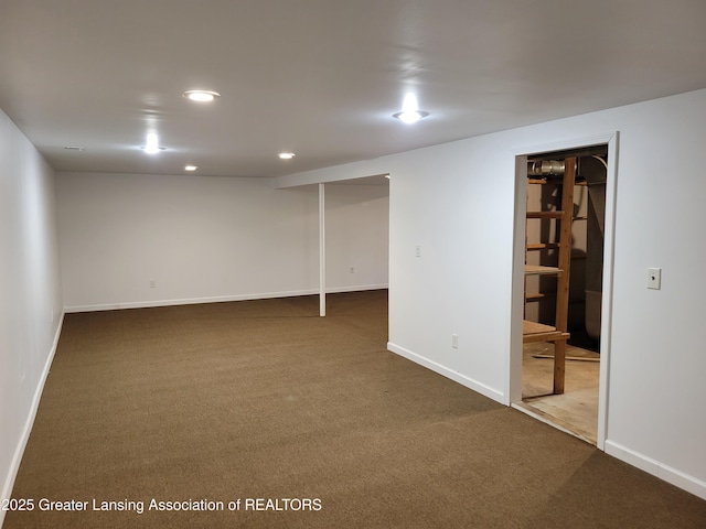 finished below grade area with recessed lighting, dark colored carpet, and baseboards