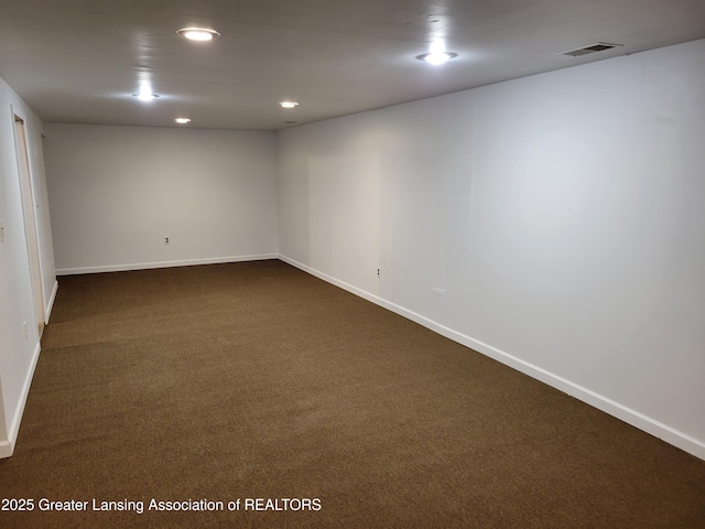 unfurnished room with baseboards, visible vents, dark colored carpet, and recessed lighting