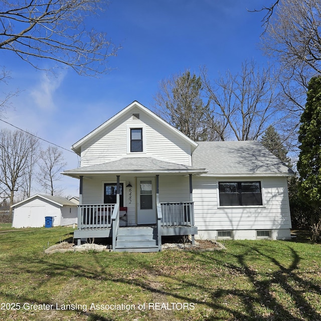 6482 Carlisle Hwy, Charlotte, MI 48813 - view of front of property with a porch, a shingled roof, and a front lawn