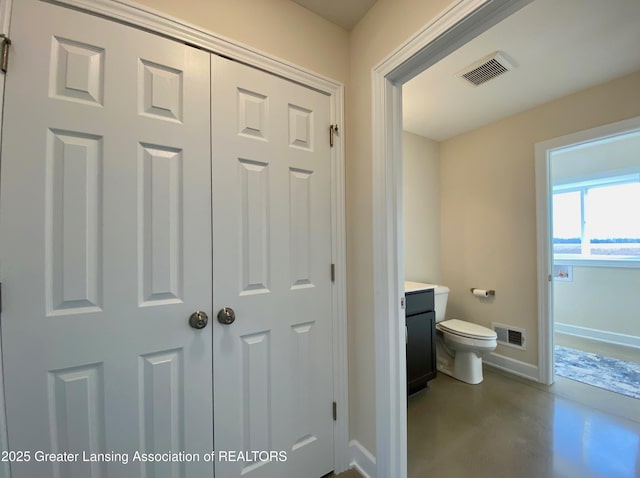 2491 W Price Rd, Saint Johns, MI 48879 - bathroom with toilet, concrete floors, baseboards, and visible vents