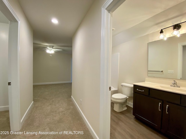 2491 W Price Rd, Saint Johns, MI 48879 - bathroom featuring toilet, ceiling fan, vanity, and baseboards