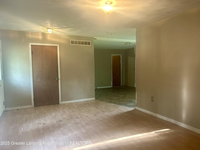3429 Lowcroft Ave, Lansing, MI 48910 - empty room featuring wood finished floors and baseboards