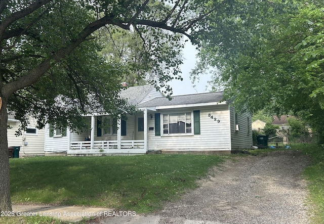 3429 Lowcroft Ave, Lansing, MI 48910 - view of front of property with covered porch, driveway, and a front yard