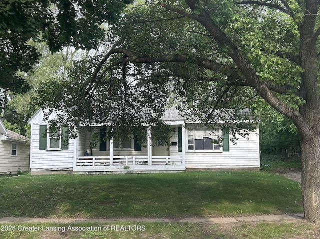 3429 Lowcroft Ave, Lansing, MI 48910 - obstructed view of property with covered porch and a front lawn