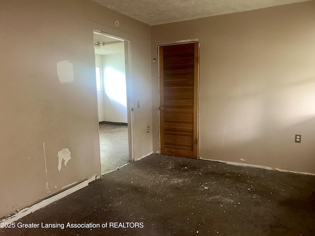 3429 Lowcroft Ave, Lansing, MI 48910 - spare room featuring a textured ceiling