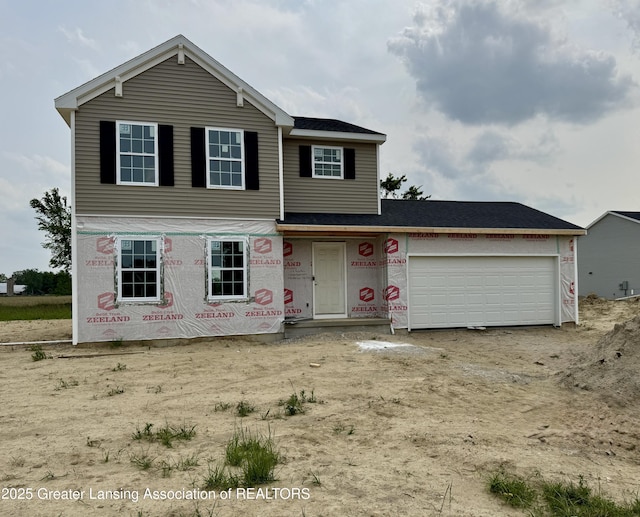 1060 Woodridge Dr, Saint Johns, MI 48879 - view of front of house featuring an attached garage and driveway