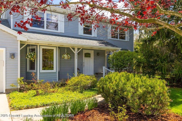traditional-style house featuring covered porch