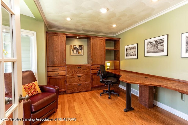 home office with built in study area, light wood-type flooring, recessed lighting, crown molding, and baseboards