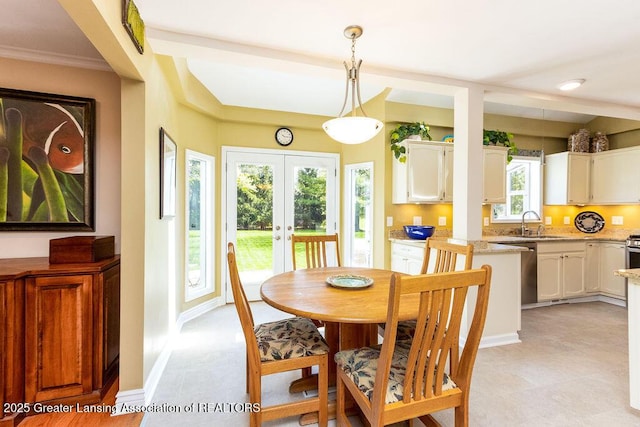 dining space featuring crown molding, baseboards, and french doors