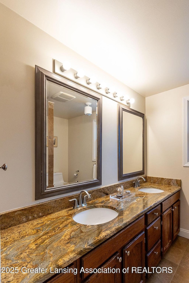 bathroom featuring a sink, double vanity, and tile patterned flooring