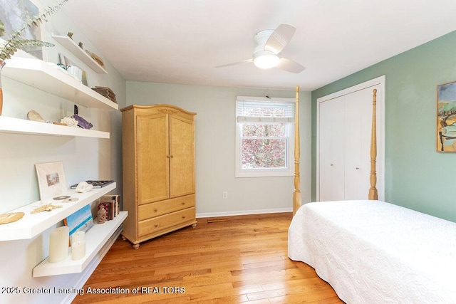 bedroom featuring a closet, light wood-style flooring, baseboards, and ceiling fan