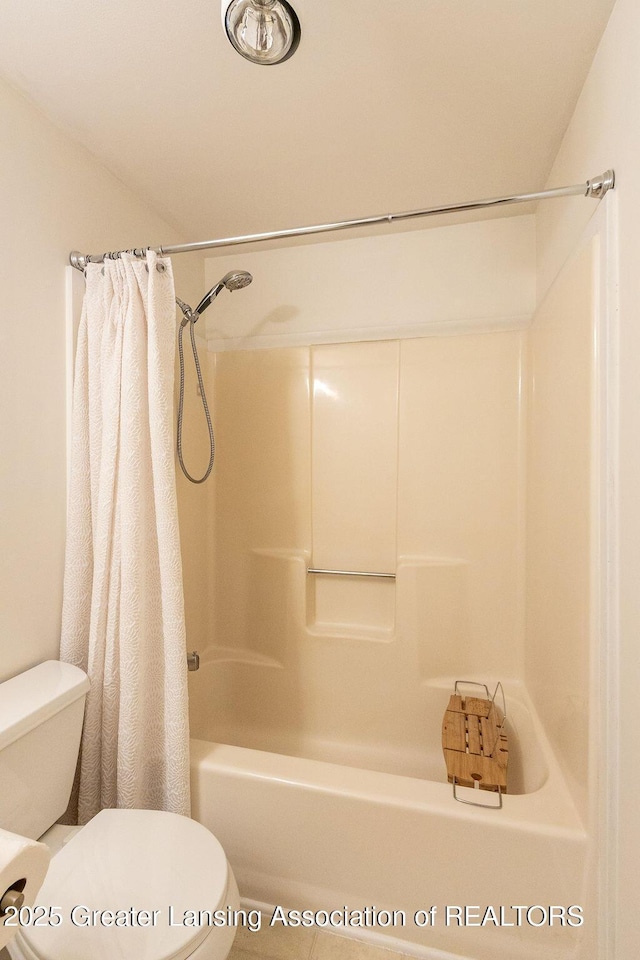 bathroom with toilet and shower / tub combo