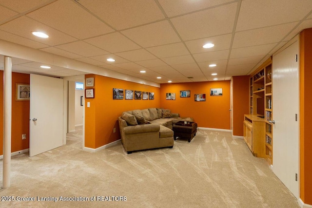living area with light colored carpet, recessed lighting, a paneled ceiling, and baseboards