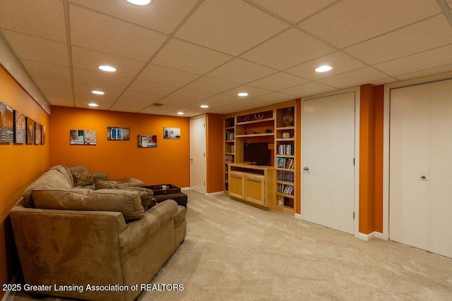 living area with baseboards, light carpet, recessed lighting, and built in features