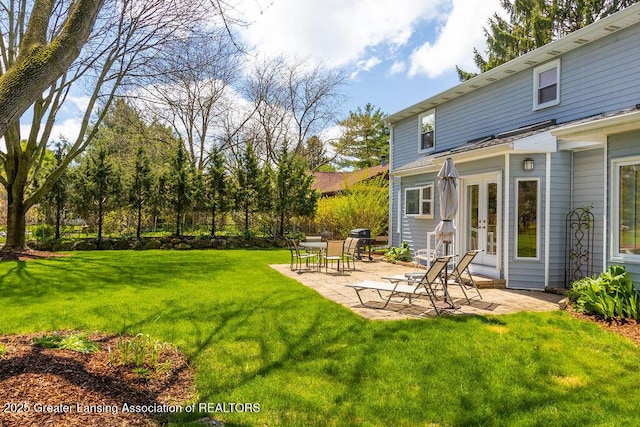 view of yard with a patio area and french doors