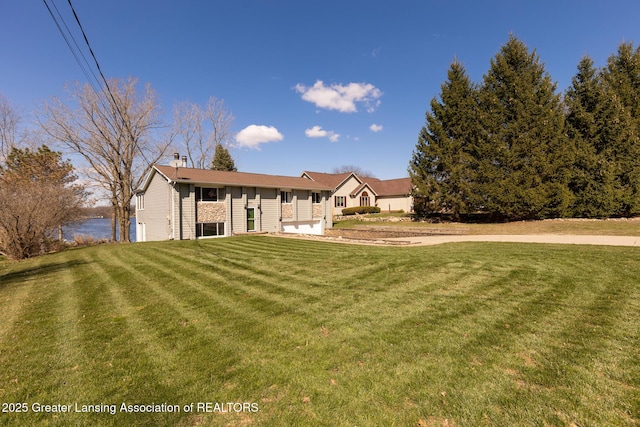 9605 Jason Rd, Laingsburg, MI 48848 - view of front of home with a chimney and a front yard
