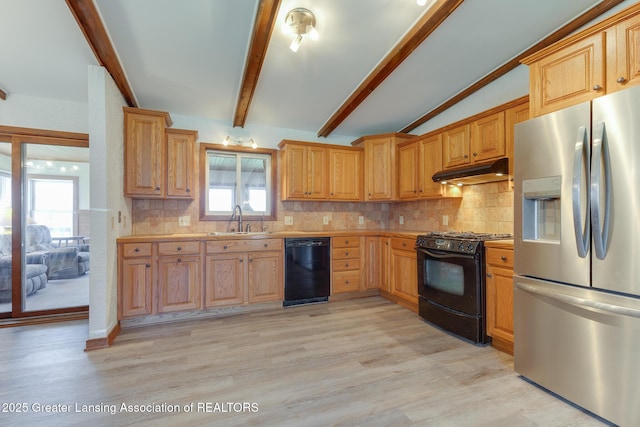 9605 Jason Rd, Laingsburg, MI 48848 - kitchen with a sink, black appliances, light wood-style floors, light countertops, and under cabinet range hood