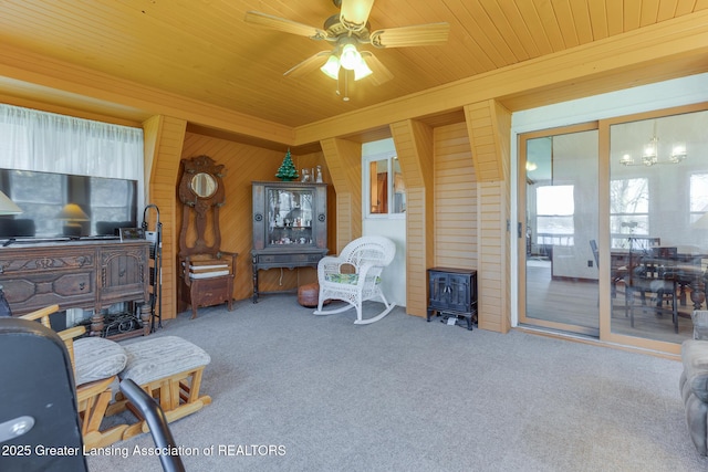 9605 Jason Rd, Laingsburg, MI 48848 - carpeted living area featuring a ceiling fan, crown molding, wooden walls, wood ceiling, and a wood stove