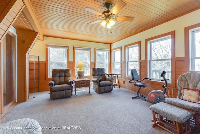 9605 Jason Rd, Laingsburg, MI 48848 - living area featuring a wainscoted wall, wooden walls, a ceiling fan, wood ceiling, and carpet flooring