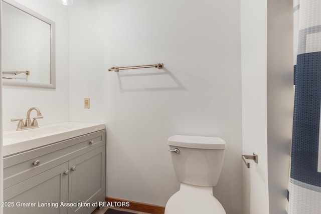9605 Jason Rd, Laingsburg, MI 48848 - bathroom featuring baseboards, vanity, and toilet