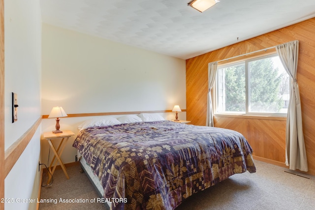 9605 Jason Rd, Laingsburg, MI 48848 - bedroom with carpet flooring, wood walls, baseboards, and visible vents