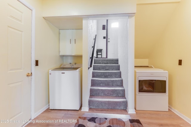 9605 Jason Rd, Laingsburg, MI 48848 - laundry room featuring baseboards, light wood-style floors, and cabinet space
