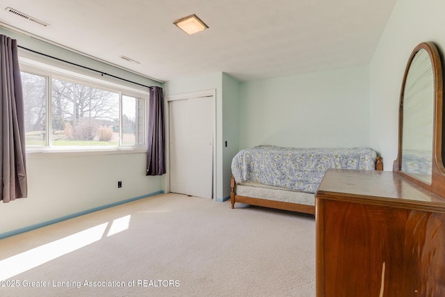 9605 Jason Rd, Laingsburg, MI 48848 - carpeted bedroom with a closet, visible vents, and baseboards