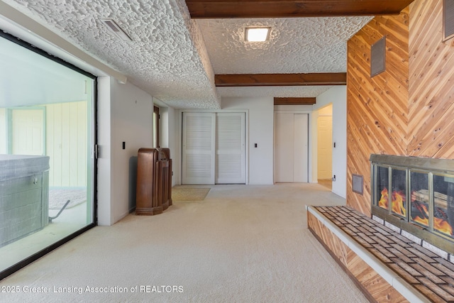 9605 Jason Rd, Laingsburg, MI 48848 - interior space with a tiled fireplace, visible vents, wood walls, and carpet floors