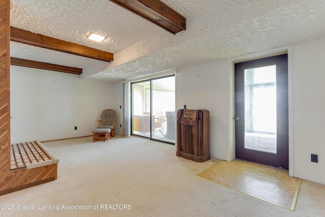 9605 Jason Rd, Laingsburg, MI 48848 - unfurnished room featuring carpet floors, beam ceiling, a textured ceiling, and plenty of natural light