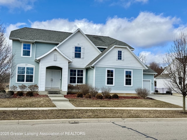 2632 Carnoustie Dr, Okemos, MI 48864 - traditional-style home featuring roof with shingles and driveway