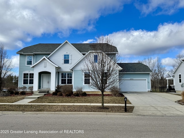2632 Carnoustie Dr, Okemos, MI 48864 - traditional-style house featuring a garage, roof with shingles, and concrete driveway