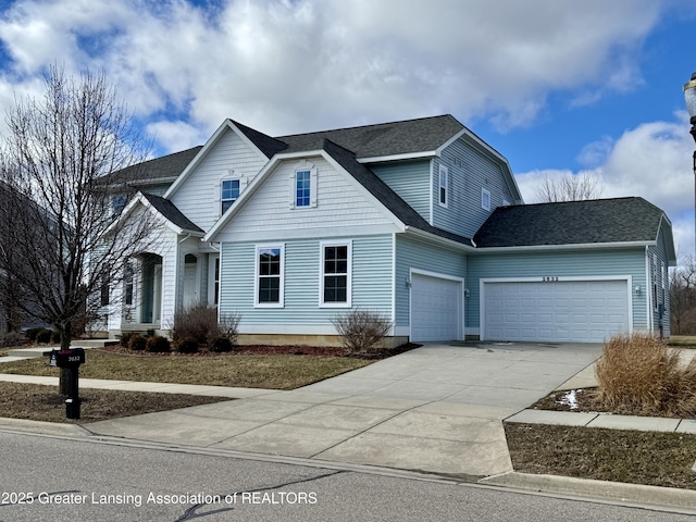 2632 Carnoustie Dr, Okemos, MI 48864 - traditional-style house featuring driveway, a garage, and roof with shingles