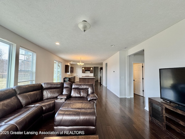 2632 Carnoustie Dr, Okemos, MI 48864 - living room featuring baseboards, a chandelier, a textured ceiling, recessed lighting, and dark wood-type flooring