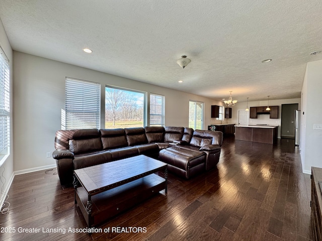 2632 Carnoustie Dr, Okemos, MI 48864 - living area featuring recessed lighting, dark wood-style floors, a textured ceiling, and an inviting chandelier