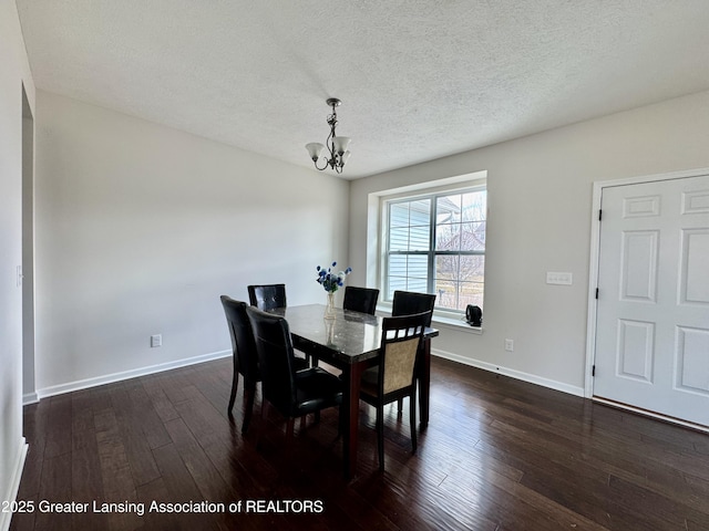 2632 Carnoustie Dr, Okemos, MI 48864 - dining room with baseboards, a textured ceiling, a notable chandelier, and dark wood finished floors